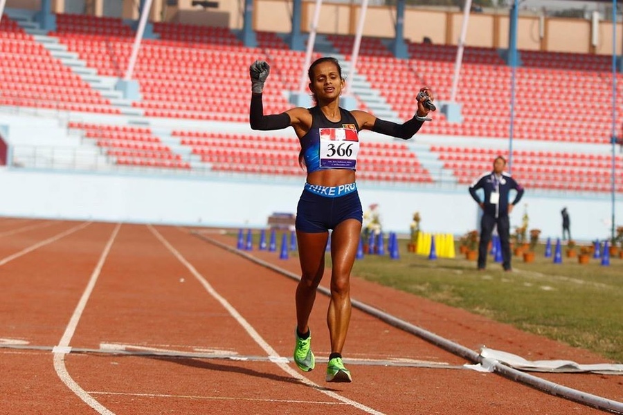 13th South Asian Games marathon winners Kiran Singh Bogati of Nepal and Hiruni Wijeyratne of Sri Lanka celebrate as they cross the finish line at Dasharath Stadium on Saturday. © 13SAGNepal.com