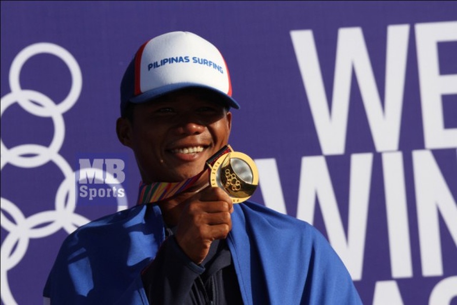 Filipino surfing hero Roger Casugay celebrates after bagging the gold medal in the men's longboard open event of the surfing competition in the 30th Southeast Asian Games. © Erwin Beleo