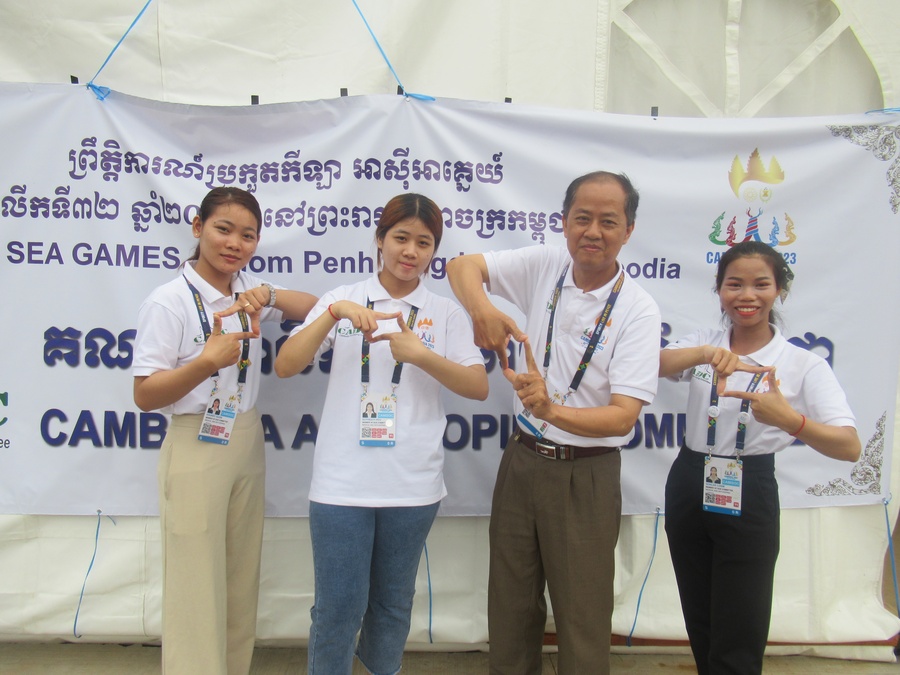 Doping Control Officer Prum Vannaroeun with some of his team outside the anti-doping education kiosk at the SEA Games.
