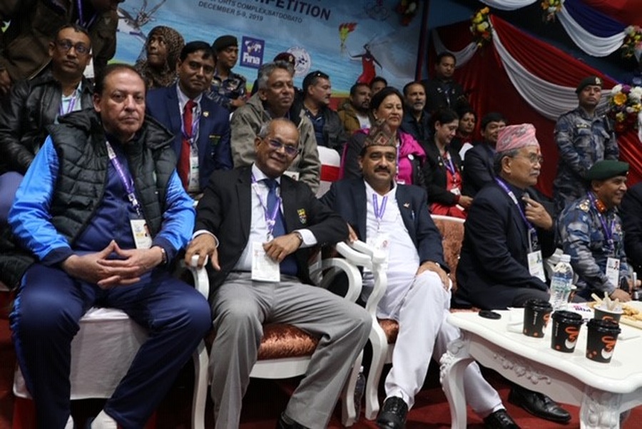 Maxwell de Silva centre with Nepals National Sports Council member secretary Ramesh Kumar Silwal right watching the swimming action.