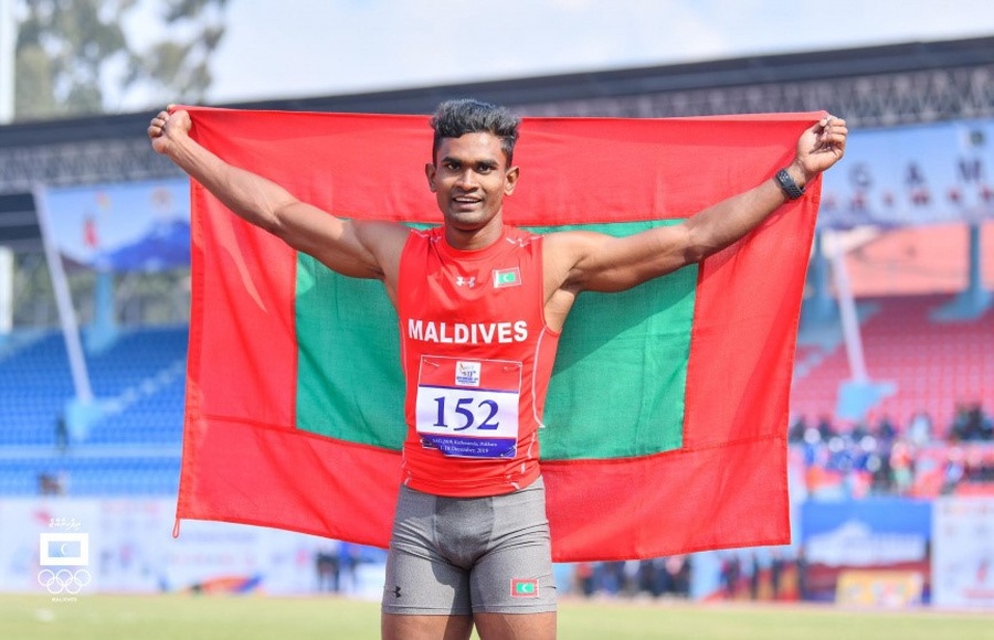 Hassan Saaid celebrates after winning the 100m gold at the 13th South Asian Games.