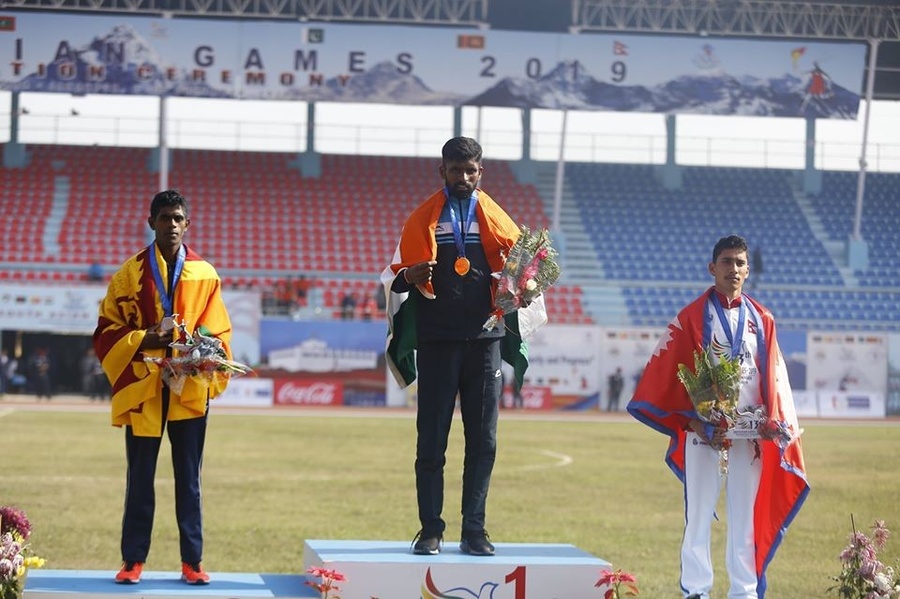 Suresh Kumar with his gold medal during the medal ceremony for the mens 10,000 metre race at the 13th South Asian Games in Kathmandu and Pokhara. ©13sagnepal.com